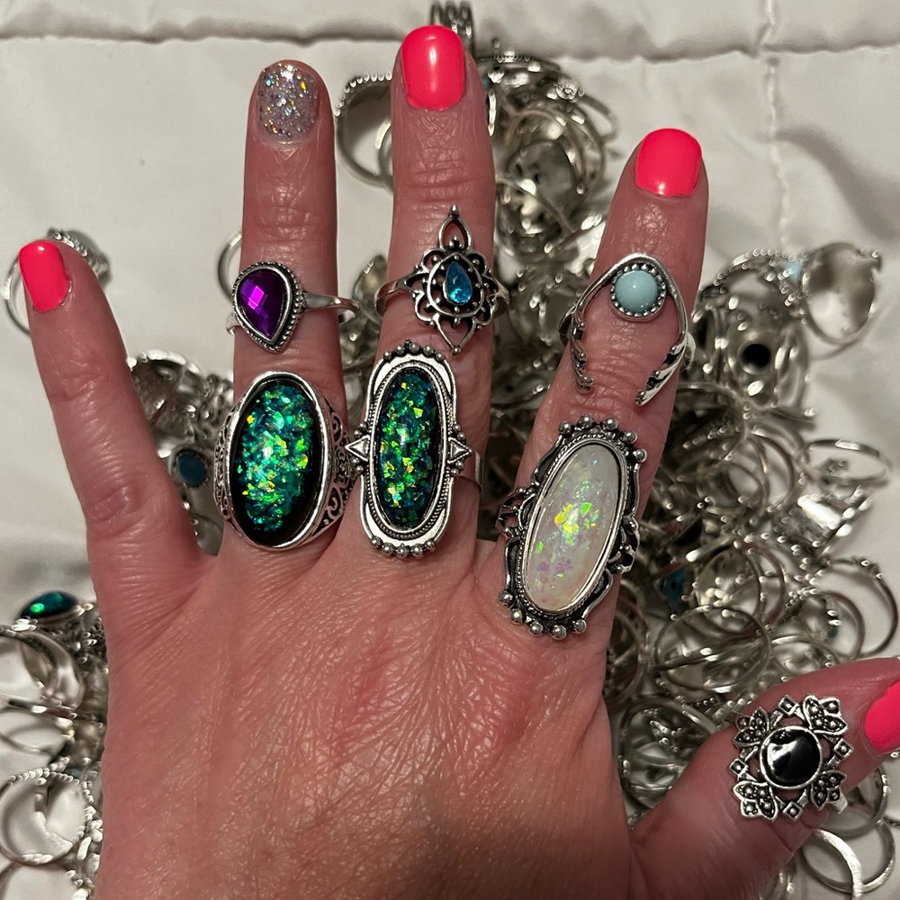 Bulk lot of various sizes and styles rings.